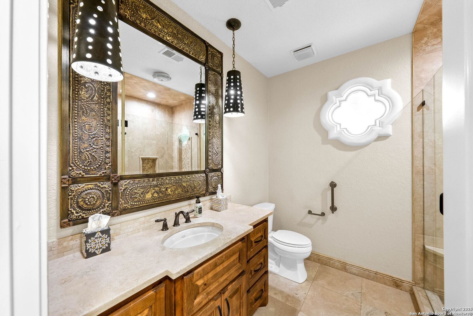 15921 Reyes Ridge Helotes, TX 78023 - Photo 35 of 68 a bathroom with a toilet sink and mirror