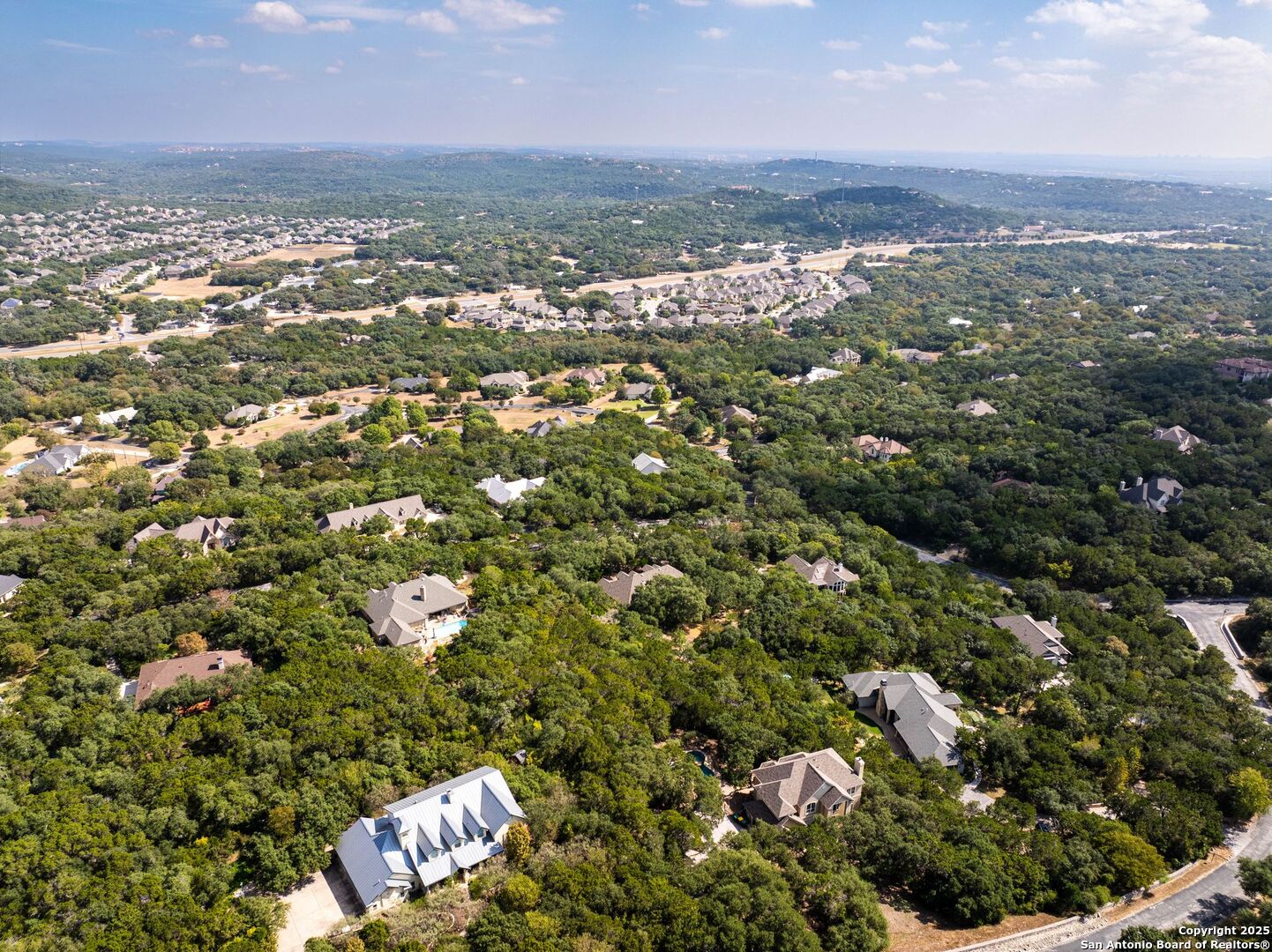 15921 Reyes Ridge Helotes, TX 78023 - Photo 59 of 68 an aerial view of residential building with parking space