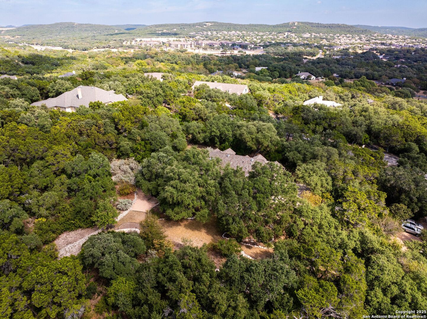 15921 Reyes Ridge Helotes, TX 78023 - Photo 68 of 68 an aerial view of residential houses with outdoor space and swimming pool