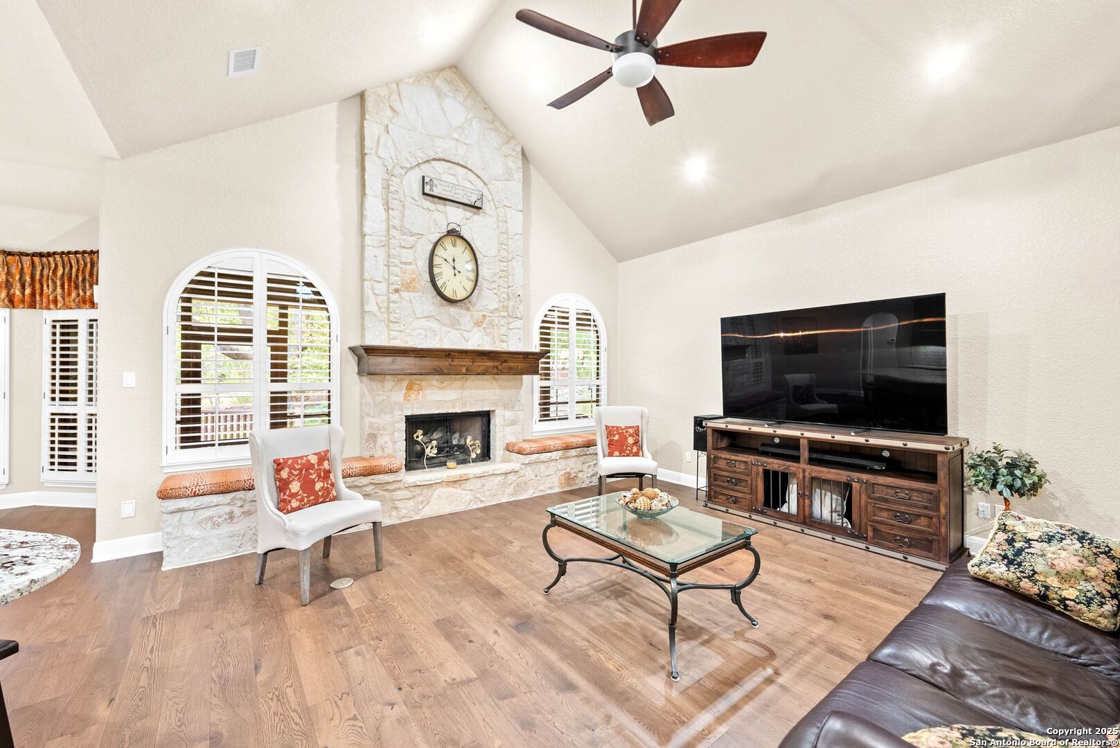 15921 Reyes Ridge Helotes, TX 78023 - Photo 7 of 68 a living room with furniture a flat screen tv and a fireplace