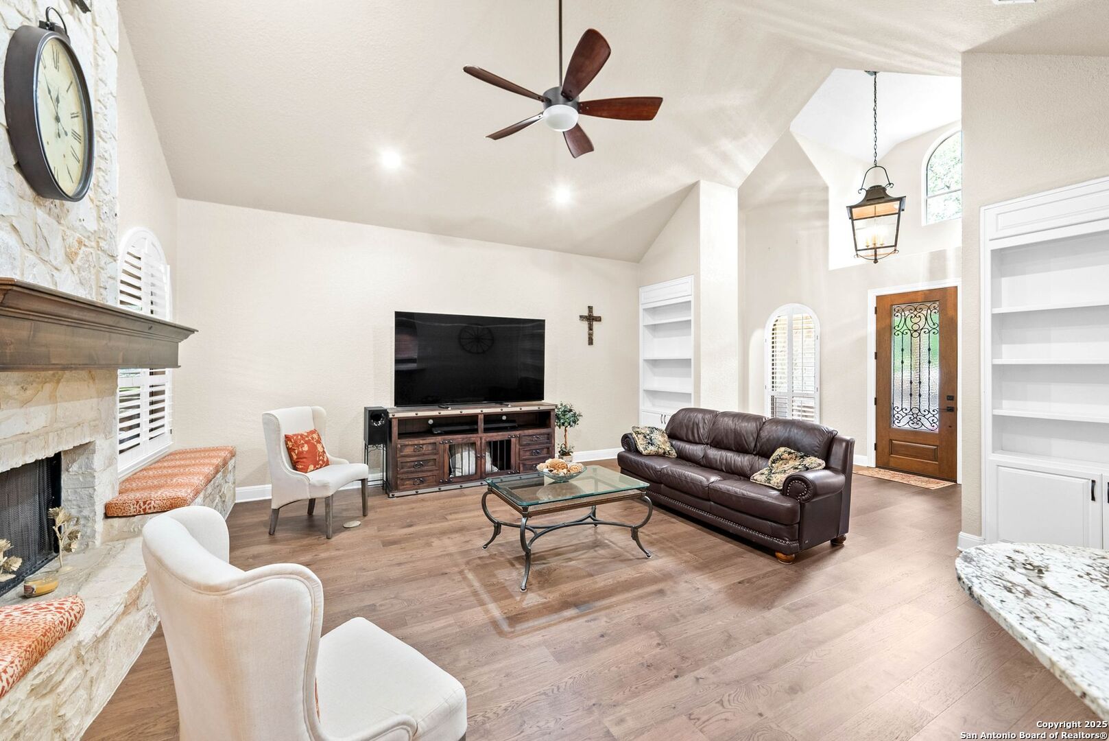 15921 Reyes Ridge Helotes, TX 78023 - Photo 8 of 68 a living room with furniture a flat screen tv and a fireplace