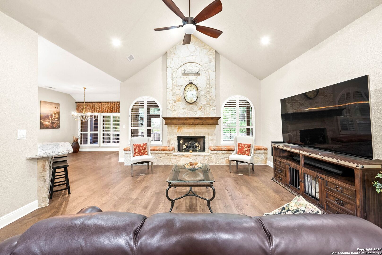 15921 Reyes Ridge Helotes, TX 78023 - Photo 9 of 68 a living room with furniture a flat screen tv and a fireplace
