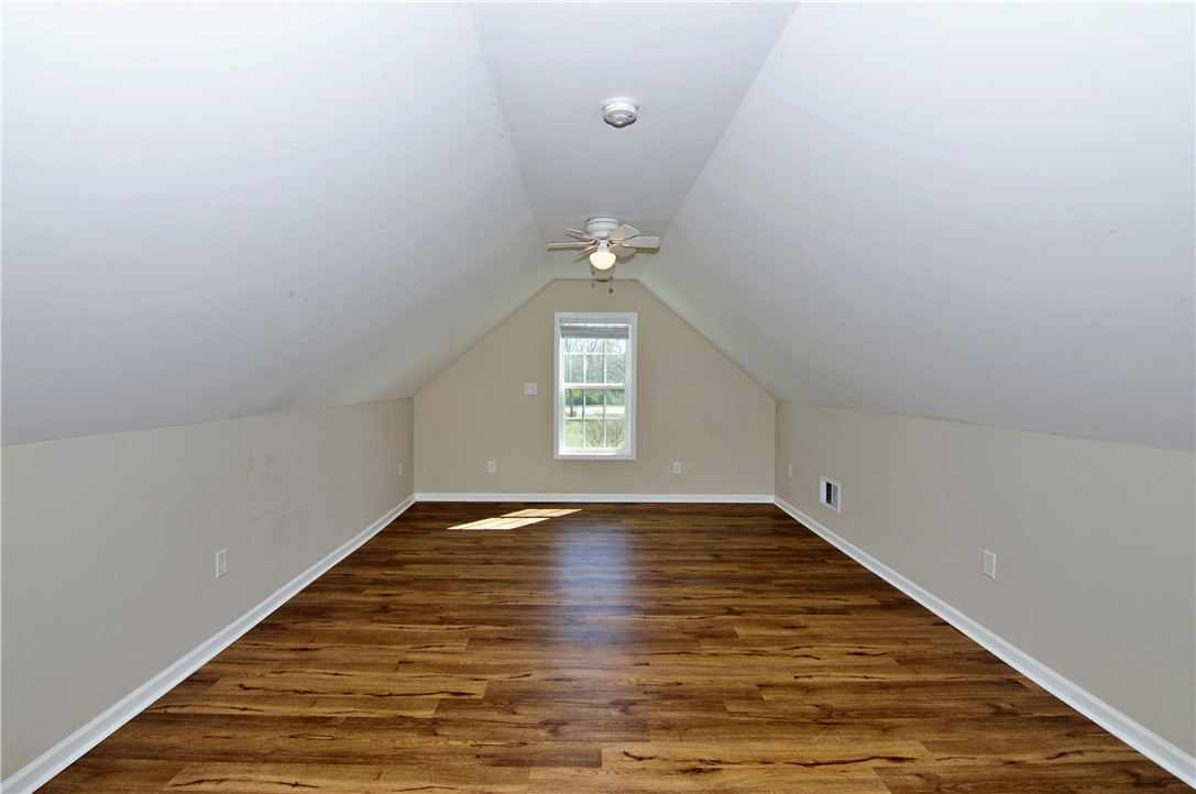 7893 Athens Road Carnesville, GA 30521 - Photo 27 of 50 This spacious attic boasts durable hardwood flooring and abundant natural light from a charming window.