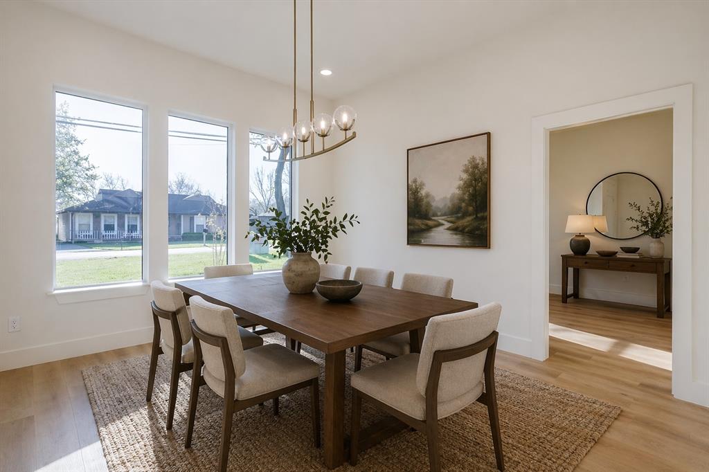 1507 Elk Creek Road Dallas, TX 75253 - Photo 12 of 40 a dining room with furniture a chandelier and wooden floor