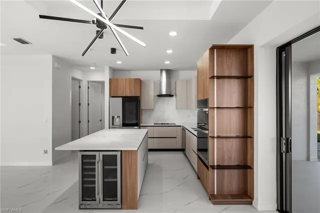 a kitchen with kitchen island a refrigerator sink and cabinets