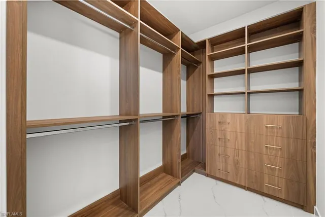 a bathroom with a sink a mirror a toilet and shower