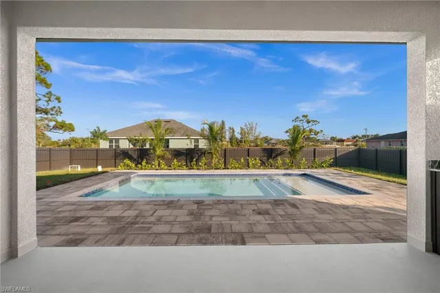 an empty room with painting on the wall