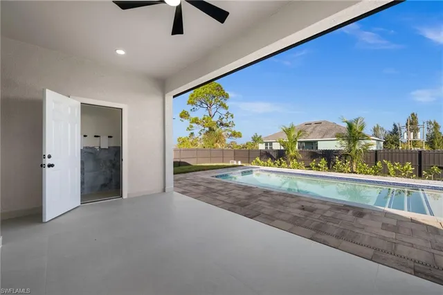 a bathroom with a granite countertop sink a mirror and bathtub