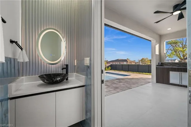 a living room with stainless steel appliances kitchen island granite countertop furniture and a flat screen tv