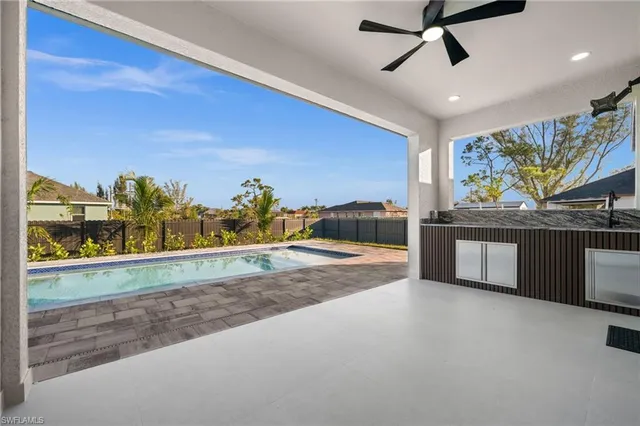 a kitchen with kitchen island a counter top space a sink stainless steel appliances and cabinets