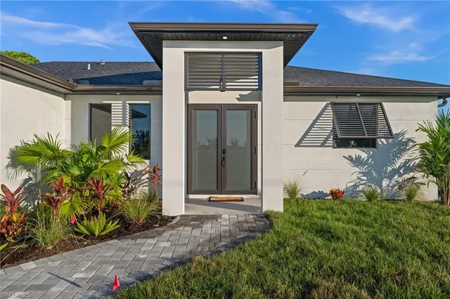 front view of a house with potted plants