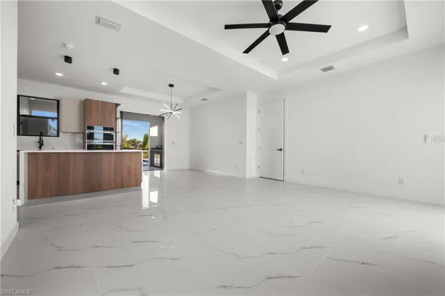 a view of a kitchen with a sink and stainless steel appliances