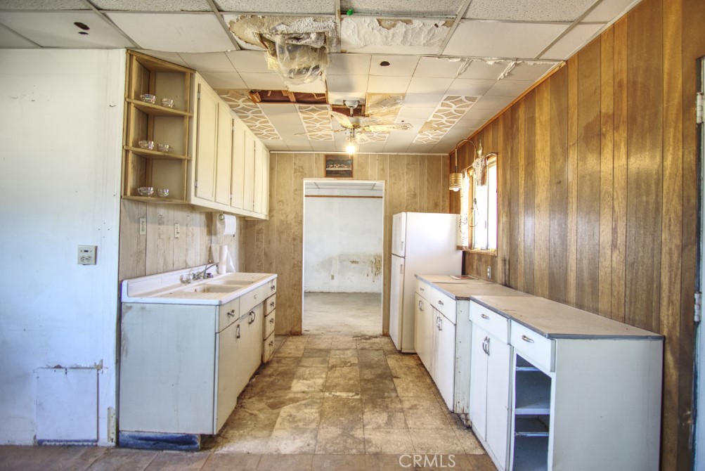 80422 Baseline Road Twentynine Palms, CA 92277 - Photo 19 of 30 a kitchen with stainless steel appliances a sink stove and cabinets