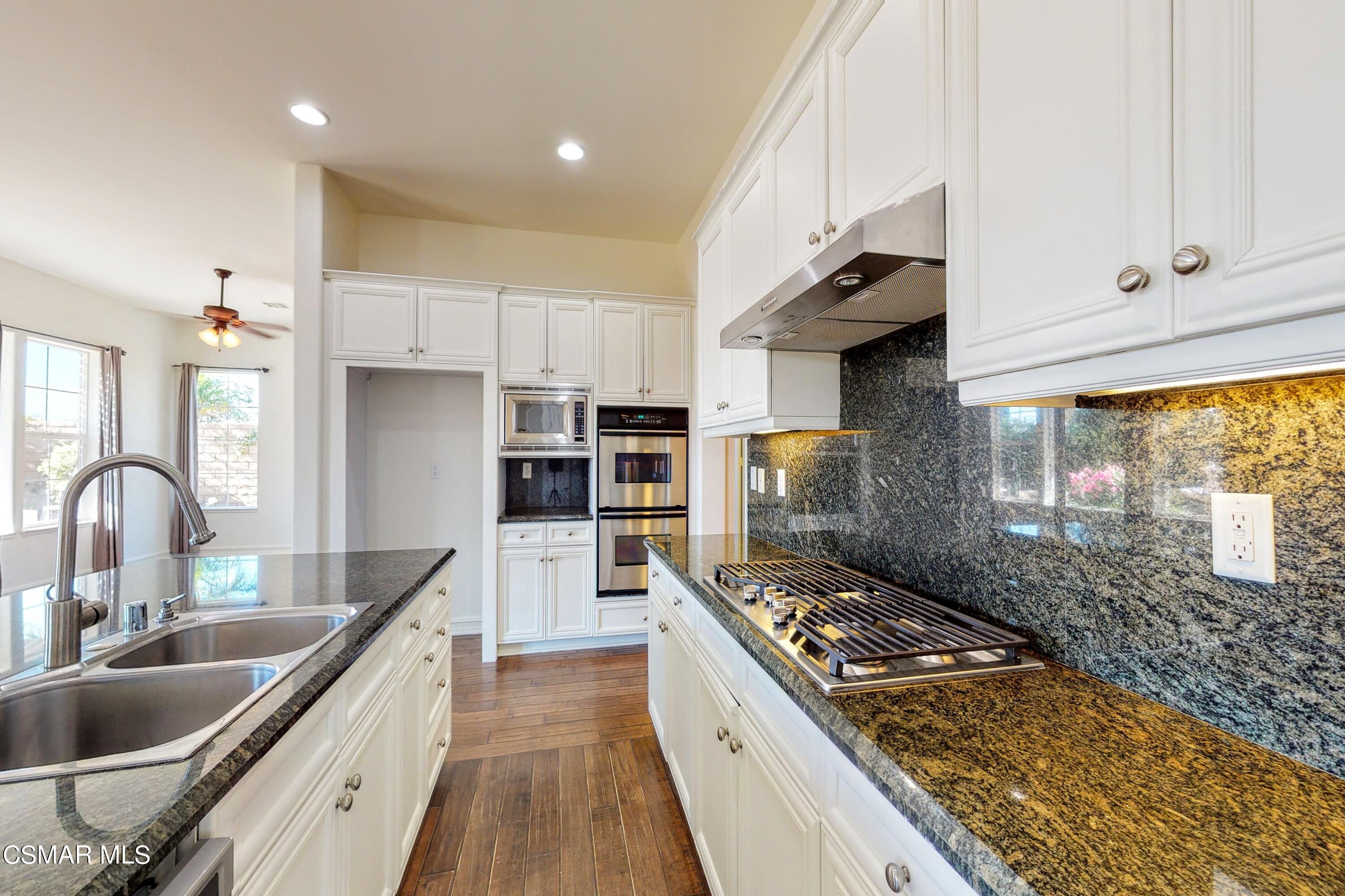 3705 Horizon Ridge Court Simi Valley, CA 93063 - Photo 12 of 62 a kitchen with kitchen island a counter top space a sink stainless steel appliances and cabinets