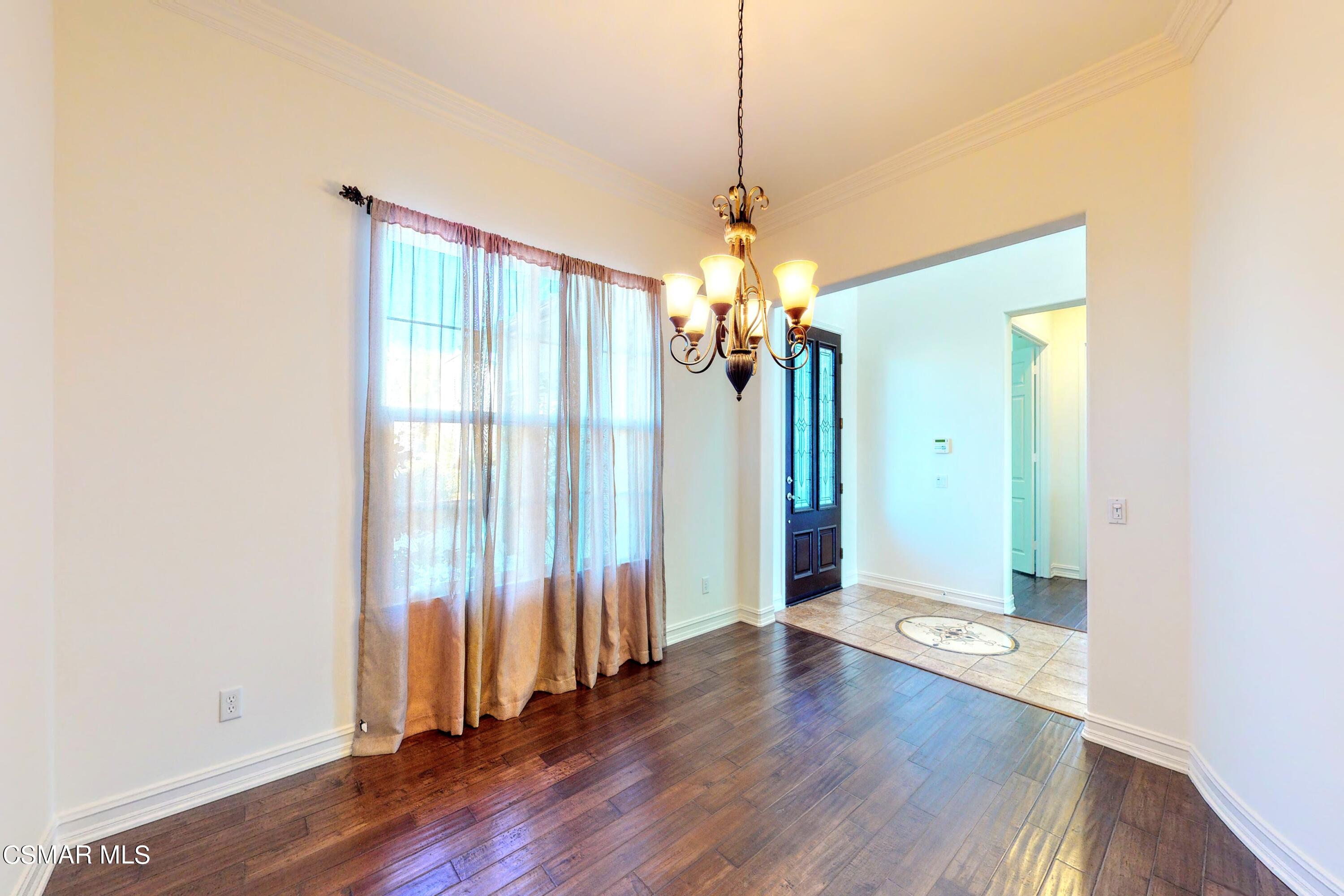3705 Horizon Ridge Court Simi Valley, CA 93063 - Photo 22 of 62 a view of a livingroom with wooden floor staircase and a chandelier