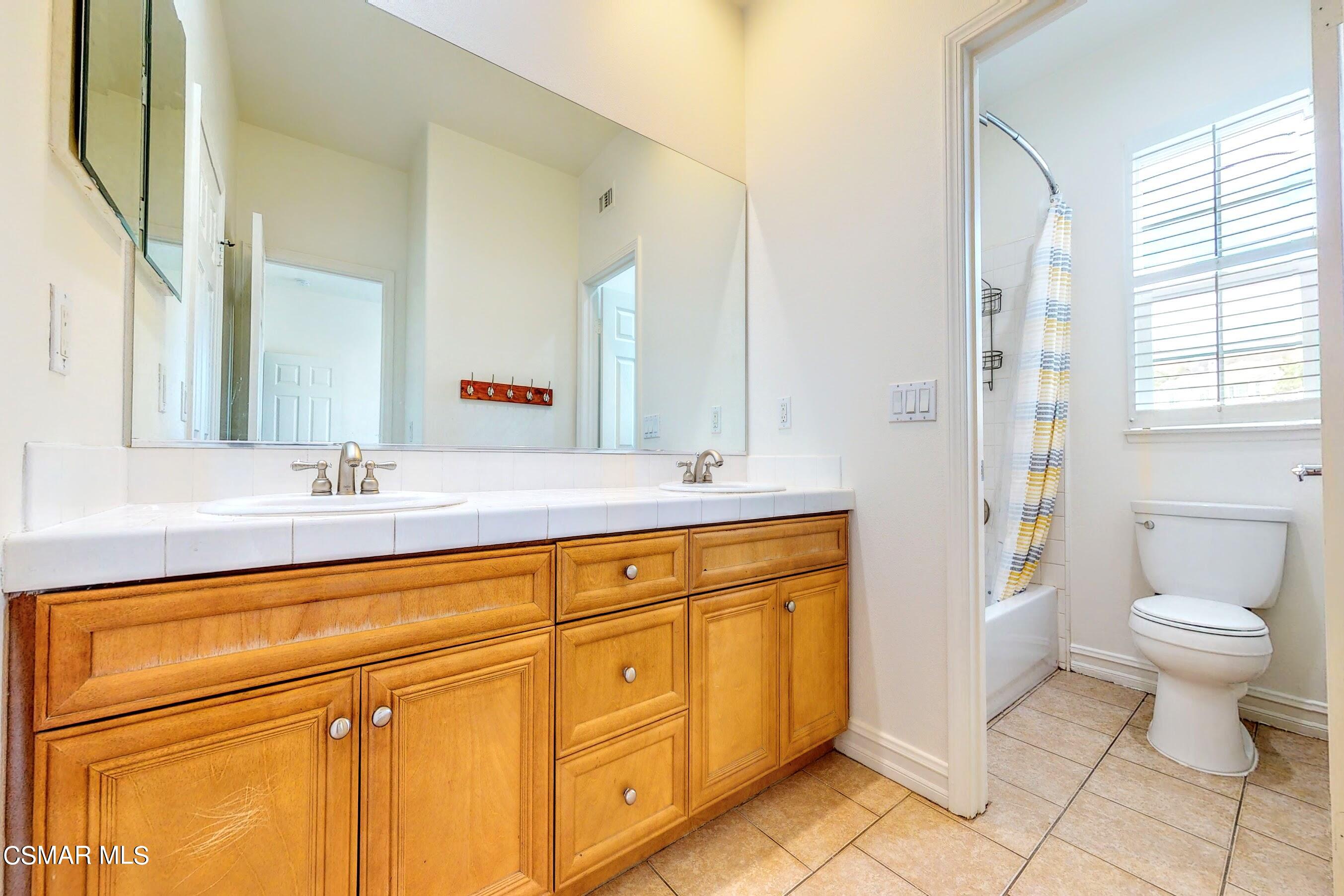 3705 Horizon Ridge Court Simi Valley, CA 93063 - Photo 52 of 62 a bathroom with a sink a toilet and a mirror