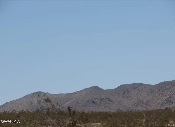 a view of a mountain range in a cloudy sky