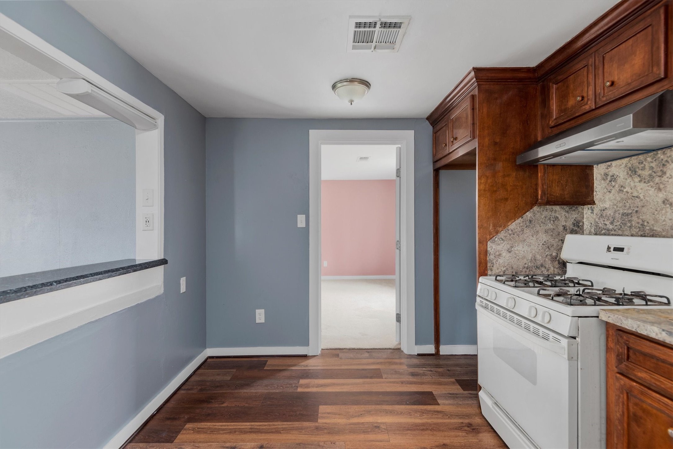 3914 Cetti Street Houston, TX 77009 - Photo 12 of 22 a kitchen with a stove and a refrigerator