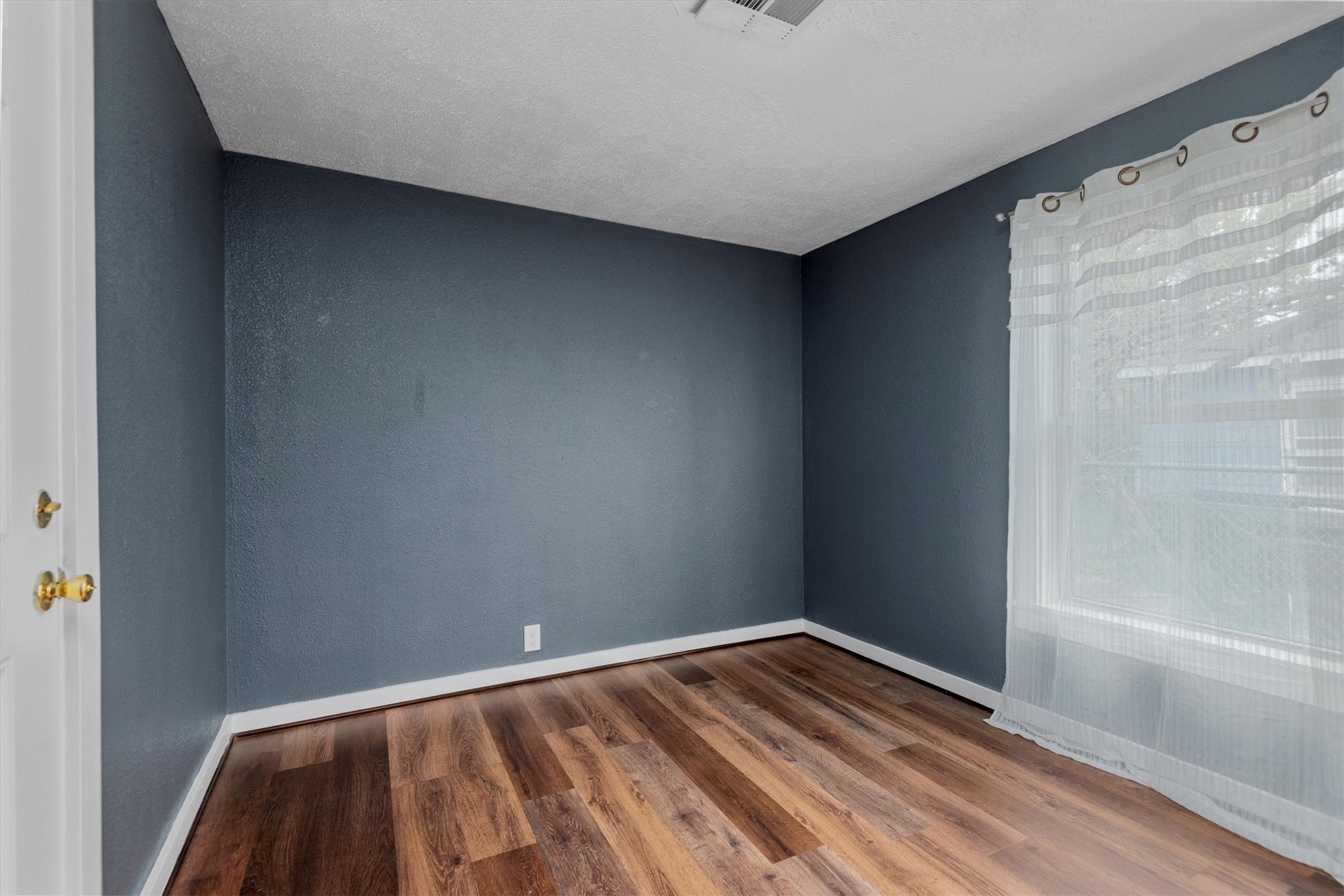 3914 Cetti Street Houston, TX 77009 - Photo 14 of 22 a view of room with window and wooden floor
