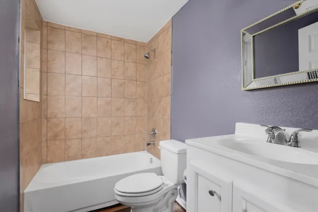 a bathroom with a toilet a sink and bathtub