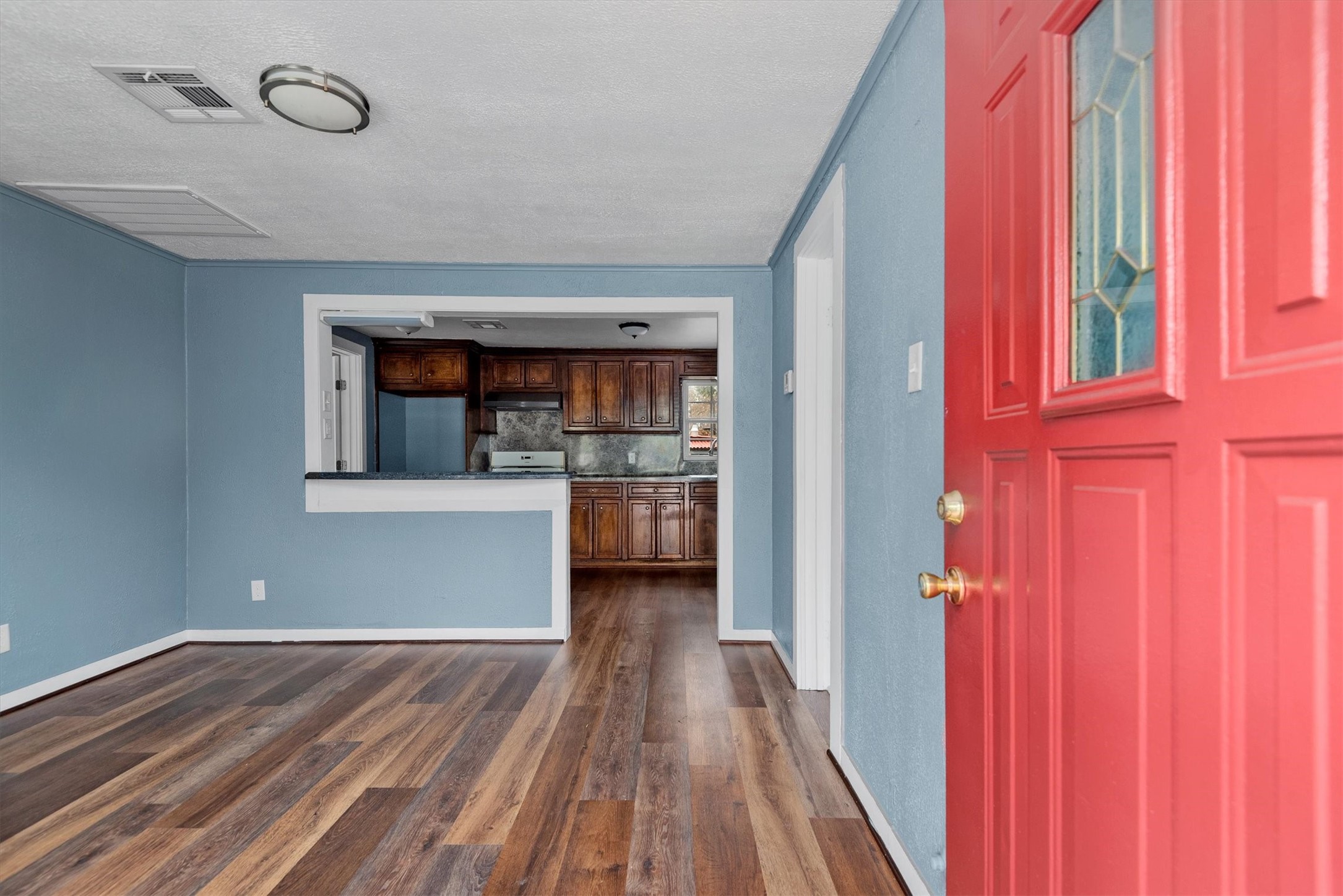 3914 Cetti Street Houston, TX 77009 - Photo 3 of 22 a view of a hallway with wooden floor and a bathroom