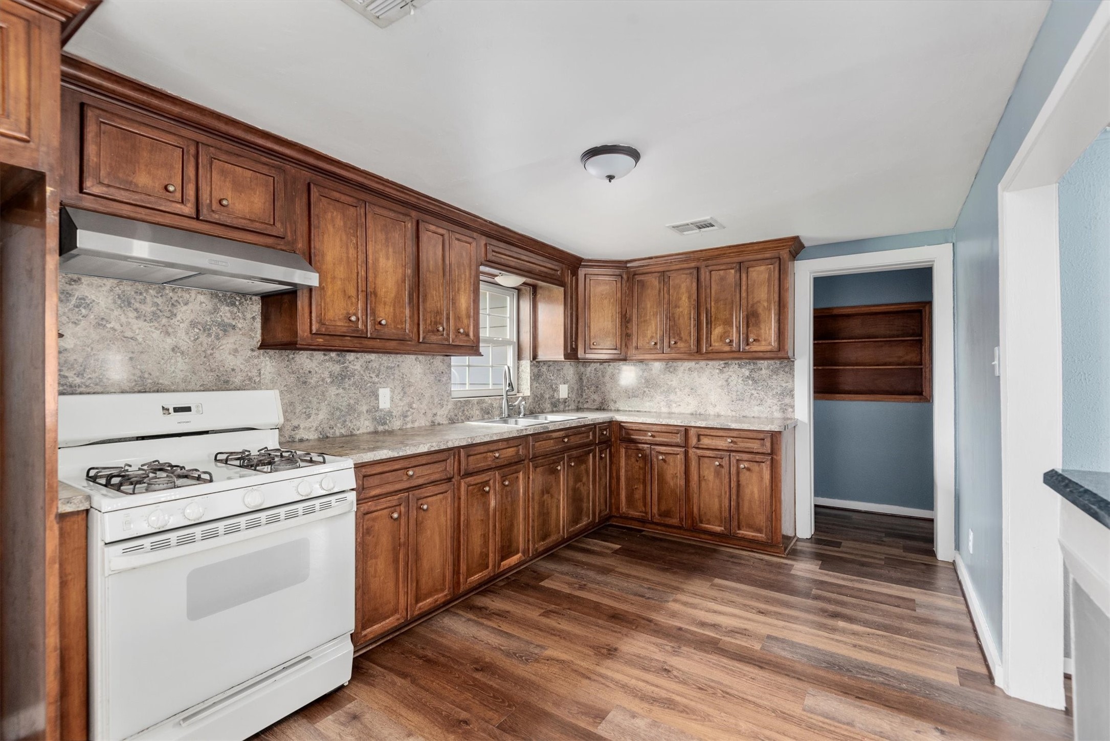 3914 Cetti Street Houston, TX 77009 - Photo 8 of 22 a kitchen with stainless steel appliances granite countertop a stove and a sink