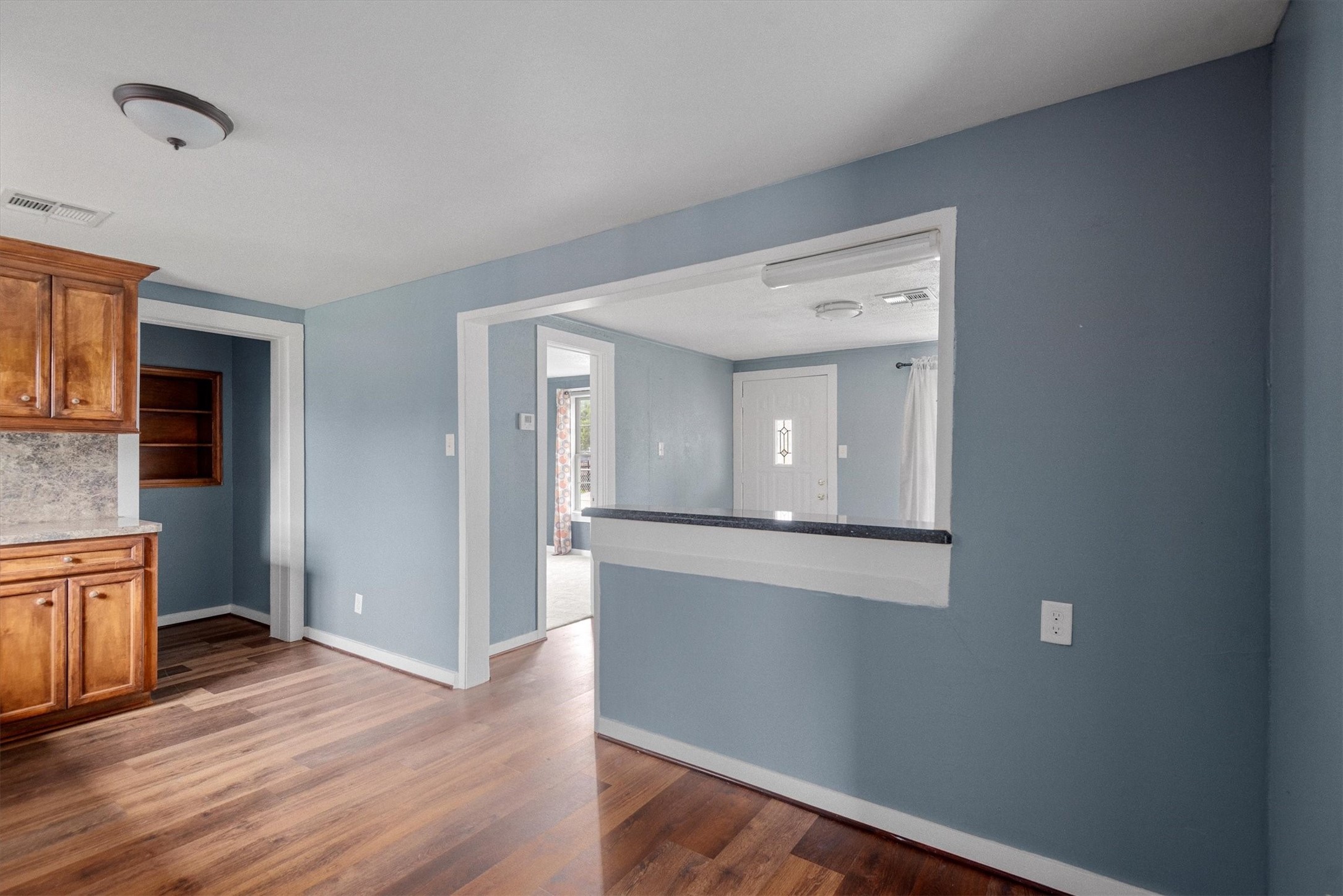3914 Cetti Street Houston, TX 77009 - Photo 9 of 22 a view of a hallway with wooden floor and staircase