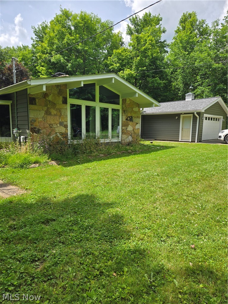 A fieldstone front and a wall of windows