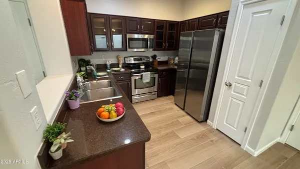 a kitchen with stainless steel appliances granite countertop a refrigerator and a stove