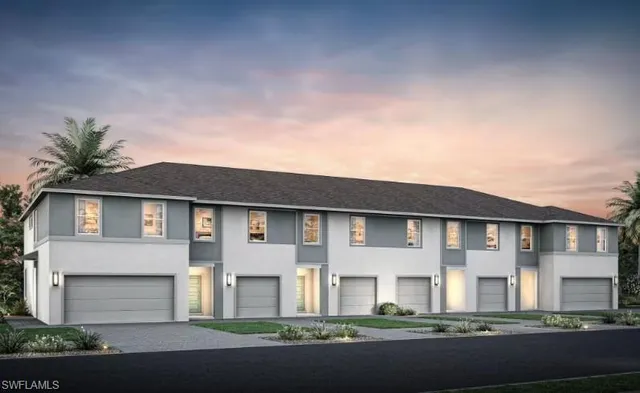 a front view of a house with a garden and yard