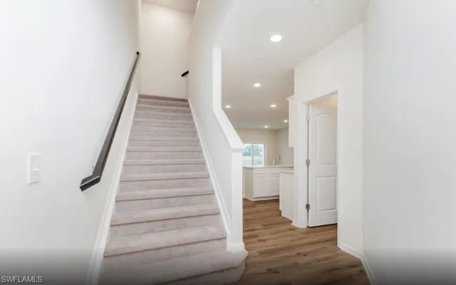 a view of entryway and hall with wooden floor