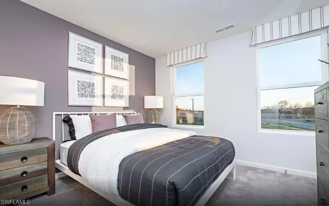 a bedroom with a bed and window