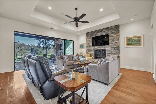 a living room with furniture fireplace and flat screen tv
