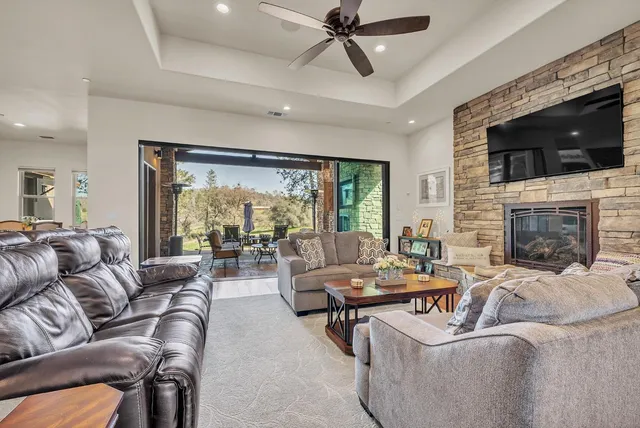 a view of a patio with a table and chairs under an umbrella