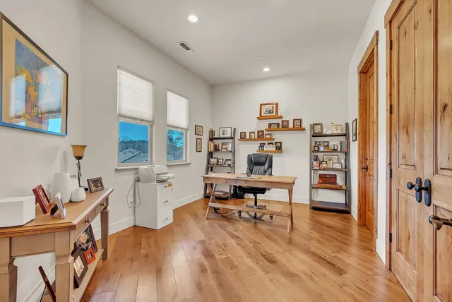 a kitchen with stainless steel appliances granite countertop a sink a stove and a wooden floors