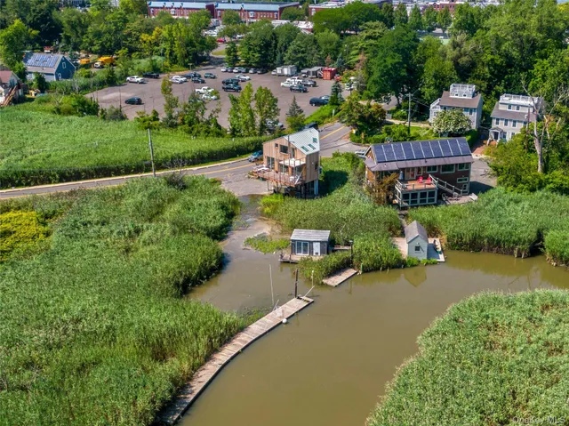 an aerial view of a house with swimming pool outdoor seating and yard