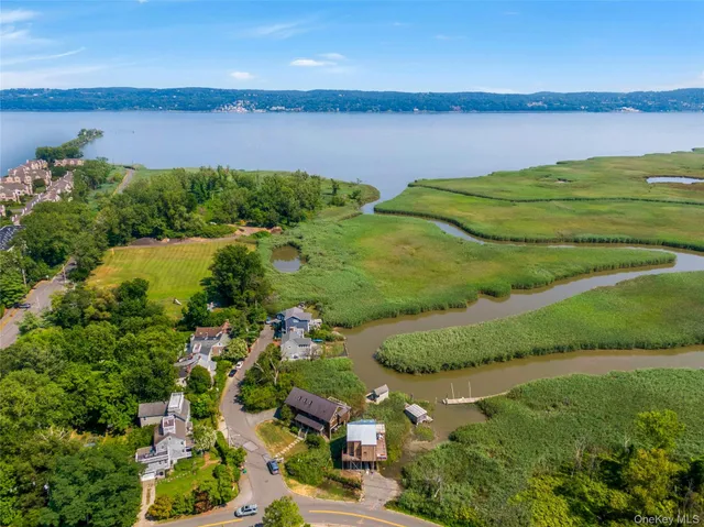 an aerial view of a houses with a lake view