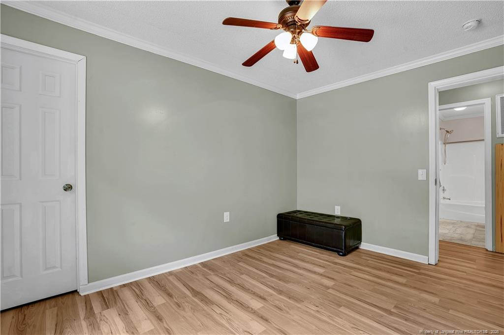 8155 Arabia Road Lumber Bridge, NC 28357 - Photo 19 of 30 an empty room with wooden floor and ceiling fan