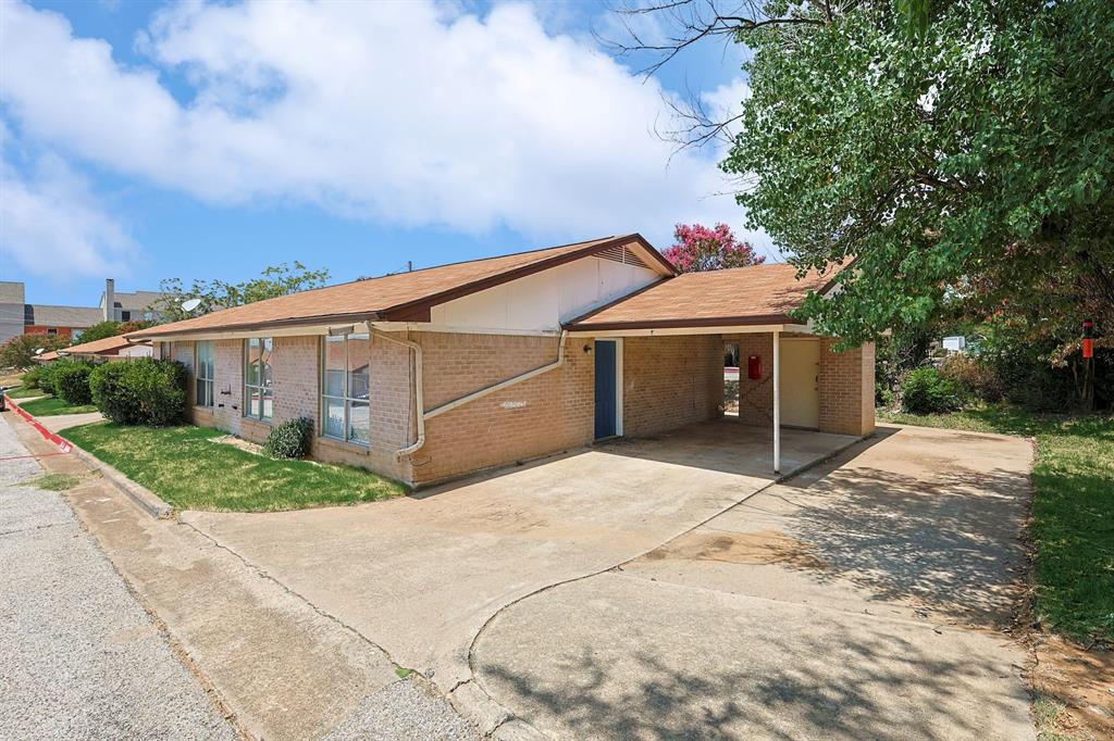 2637 West Randol Mill Road, Unit C Arlington, TX 76012 - Photo 2 of 7 a front view of a house with a yard and garage