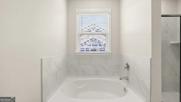 a white bath tub sitting next to a white sink