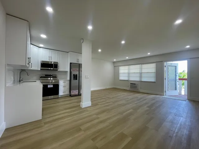 a view of a kitchen with a sink and a stove top oven