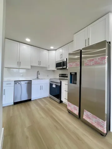 a kitchen with stainless steel appliances a refrigerator and a stove