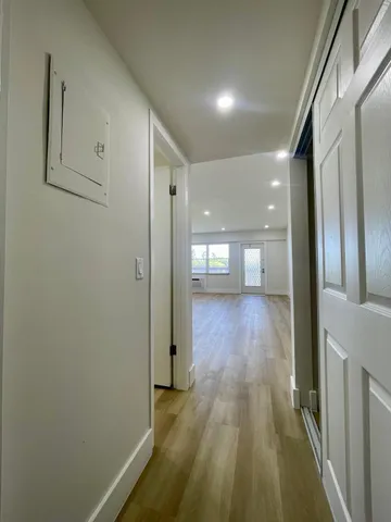 a view of gallery with wooden floor