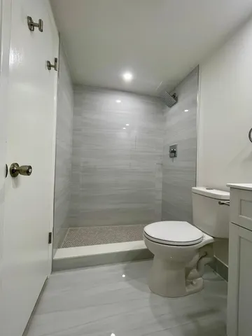 a bathroom with a toilet a sink and mirror