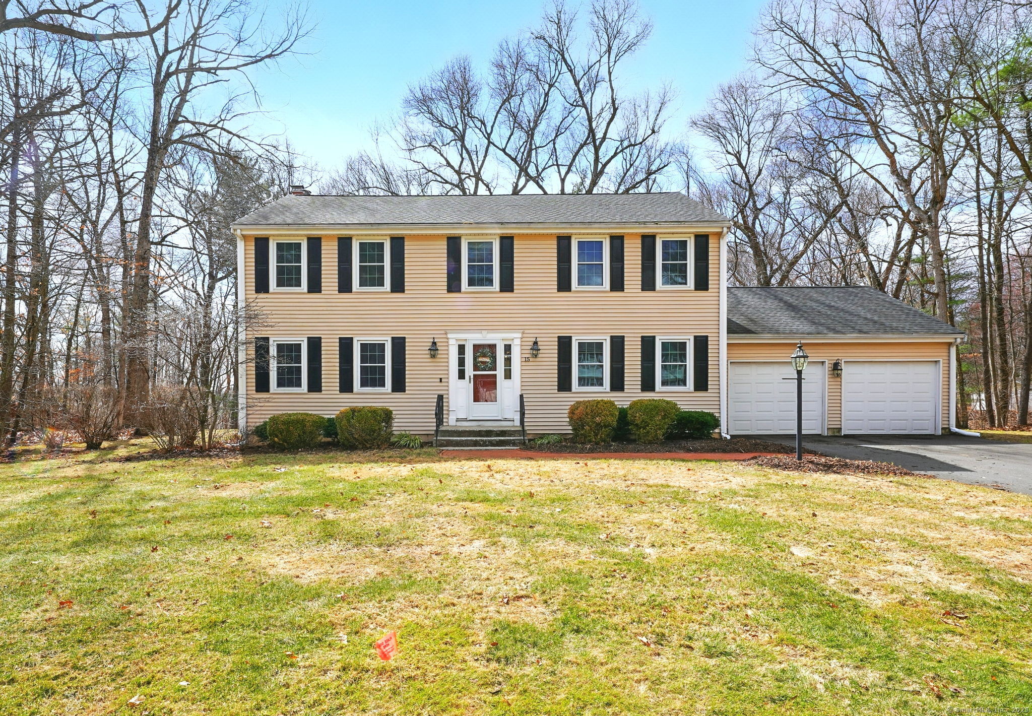 15 Wells Road Ellington, CT 06029 - Photo 1 of 1 a house that has a big yard with plants and trees in front of it