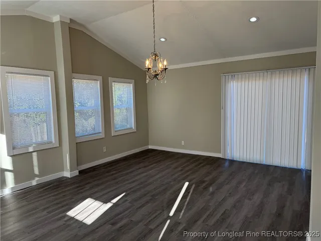 an empty room with a ceiling fan and window
