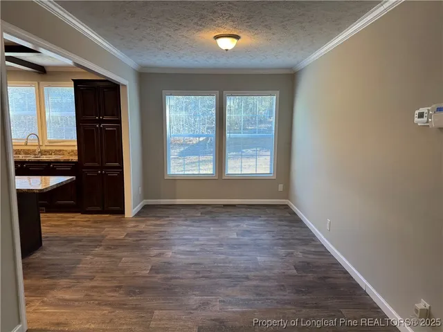 a kitchen with stainless steel appliances kitchen island granite countertop wooden cabinets a refrigerator and a sink