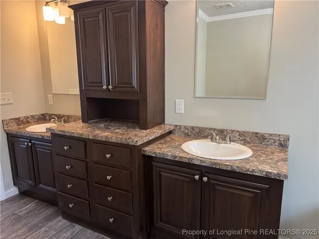 a sink granite counter top a stove microwave and cabinets