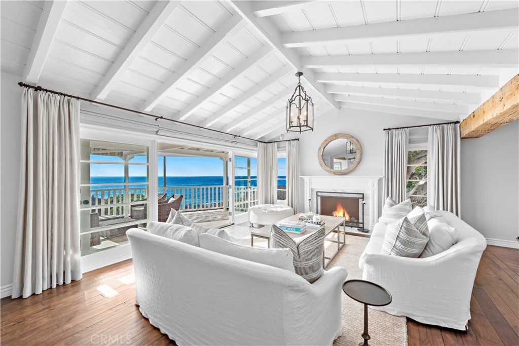 1810 Ocean Way Laguna Beach, CA 92651 - Photo 4 of 5 a living room with furniture a clock and a large window