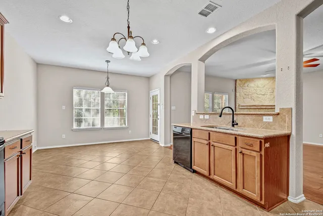 a spacious bathroom with a granite countertop sink a mirror and a bathtub with shower